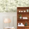 green botanical wallpaper and wall with chair and cabinets