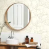 white botanical wallpaper and wall with cabinets and towel