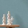 blue plain wallpaper and wall with side table and vases