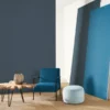 blue plain wallpaper and wall with armchair and side table