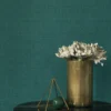 green plain wallpaper and wall with side table and vases