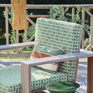 neutral geometric armchair with vases and plants