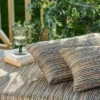 orange striped sofa with cushion and vases