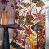 green animal curtain with side table and vases