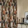 green geometric curtain with side table and vases