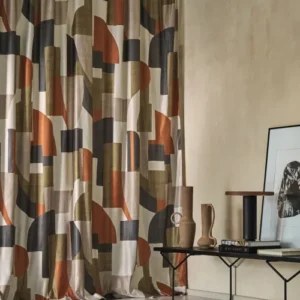 green geometric curtain with side table and vases