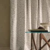 white geometric curtain with coffee table and vases