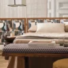 neutral plain bed with side table and pouf