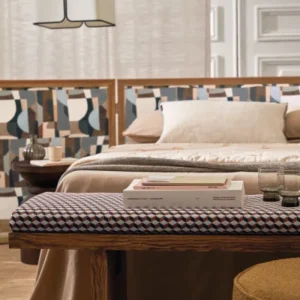 neutral plain bed with side table and pouf