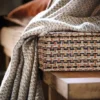 white striped curtain with cushion and wooden bench