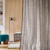 neutral striped curtain with pouf and lamps
