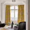 yellow geometric curtain with coffee table and armchair