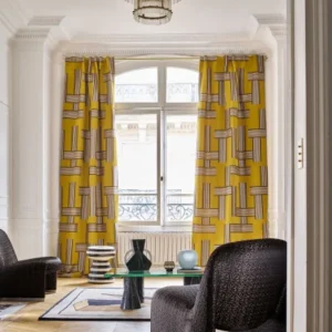 yellow geometric curtain with coffee table and armchair