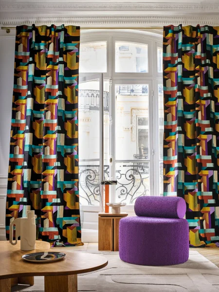 Polychromie Fabric - Topaze Ultraviolet by black-grey geometric curtain with pouf and coffee table