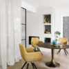 green plain curtain with armchair and dining table