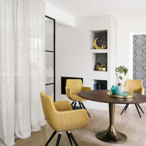 green plain curtain with armchair and dining table
