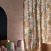 yellow botanical curtain with pouf and vases