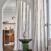 neutral striped curtain with side table and window