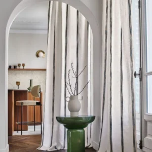 neutral striped curtain with side table and window