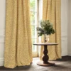 orange checked curtain with cushion and vases