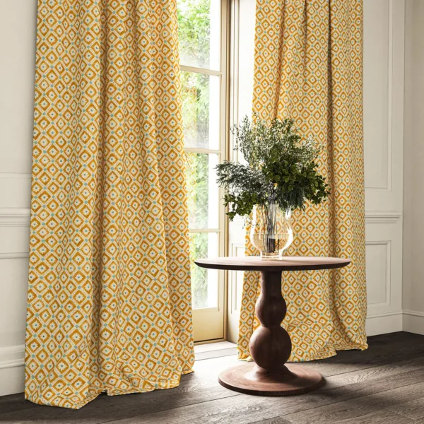 Ima Fabric - Marigold by orange checked curtain with cushion and vases