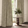 black-grey checked curtain with cushion and vases