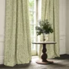 green traditional curtain with cushion and vases