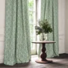 blue traditional curtain with cushion and vases