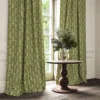 green traditional curtain with cushion and vases