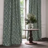 blue traditional curtain with cushion and vases