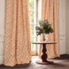 red botanical curtain with cushion and vases