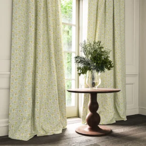 yellow botanical curtain with cushion and vases