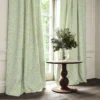 yellow botanical curtain with cushion and vases