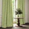 yellow botanical curtain with cushion and vases