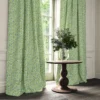 green botanical curtain with cushion and vases