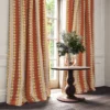 red striped curtain with cabinets and vases