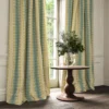 blue striped curtain with cabinets and vases