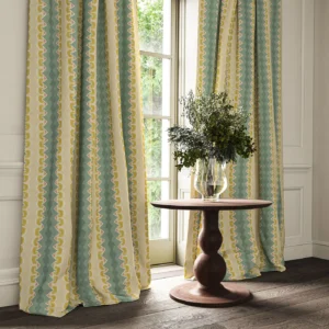 blue striped curtain with cabinets and vases