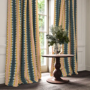 blue striped curtain with side table and vases
