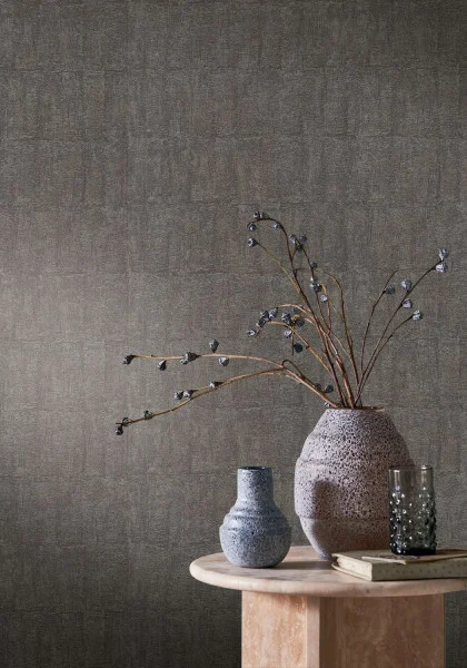 Bizen Wallpaper - Anthracite by brown plain wallpaper and wall with side table and vases