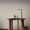 black-grey geometric wallpaper and wall with side table and lamps
