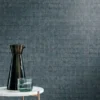 blue geometric wallpaper and wall with side table and vases