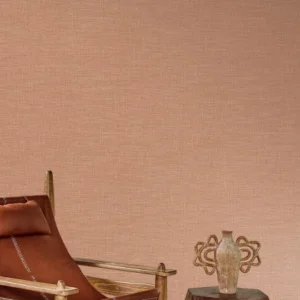 pink plain wallpaper and wall with armchair and vases