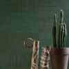 green geometric wallpaper and wall with vases