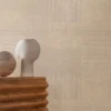neutral geometric wallpaper and wall with side table and vases