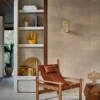 white geometric wallpaper and wall with armchair and vases