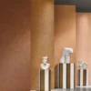 brown striped wallpaper and wall with pouf and vases