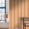 pink striped wallpaper and wall with chair and lamps