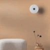 orange plain wallpaper and wall with pouf and vases