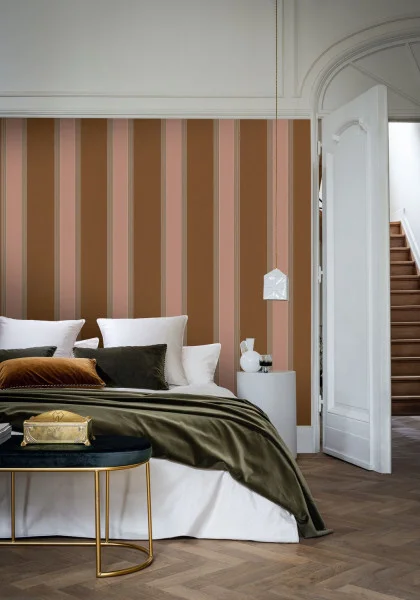 Auteuil Wallpaper - Ambre / Nude by brown striped wallpaper and wall with bed and coffee table